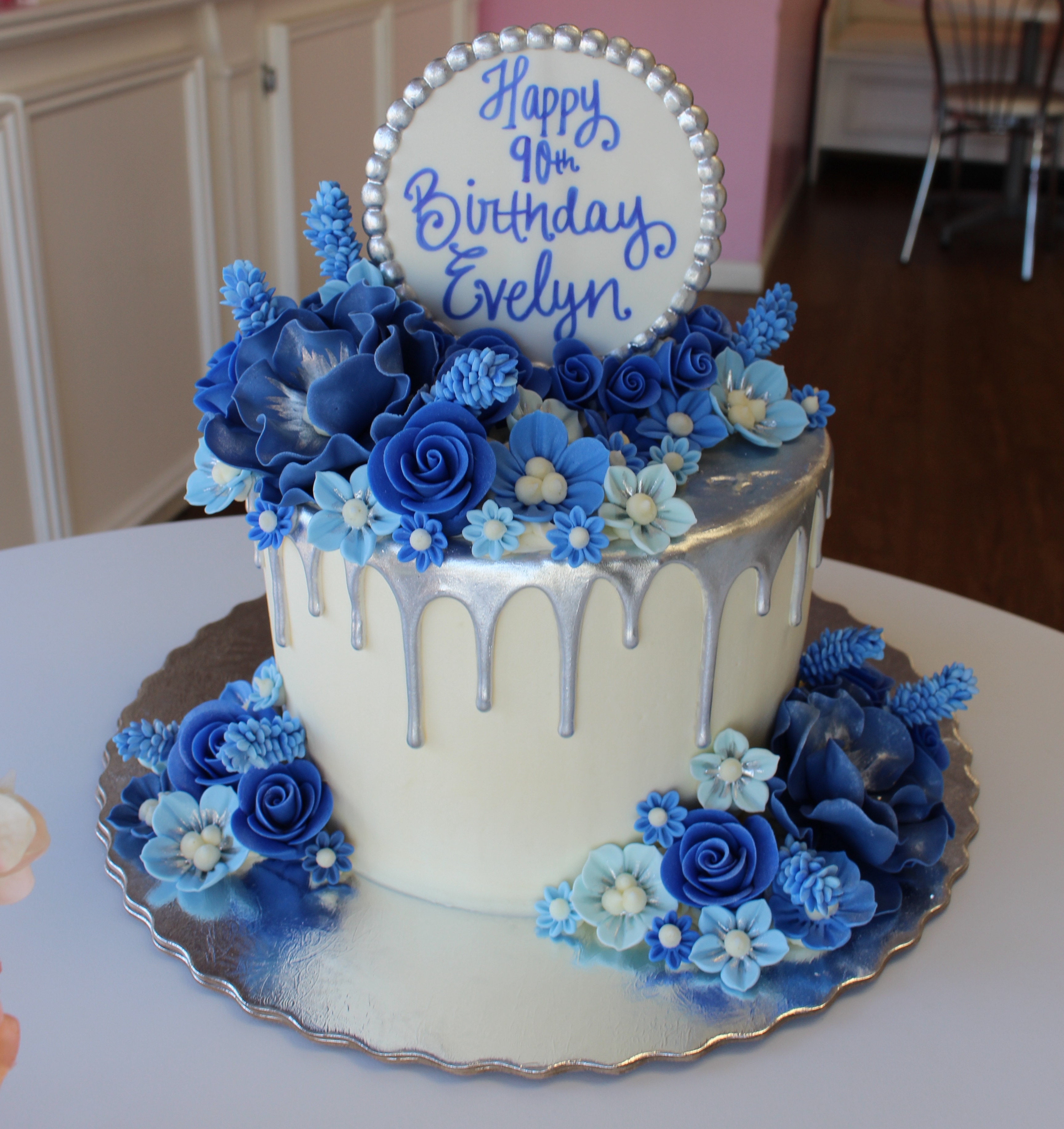 Silver and White Drip Cake with Blue Fondant Flowers