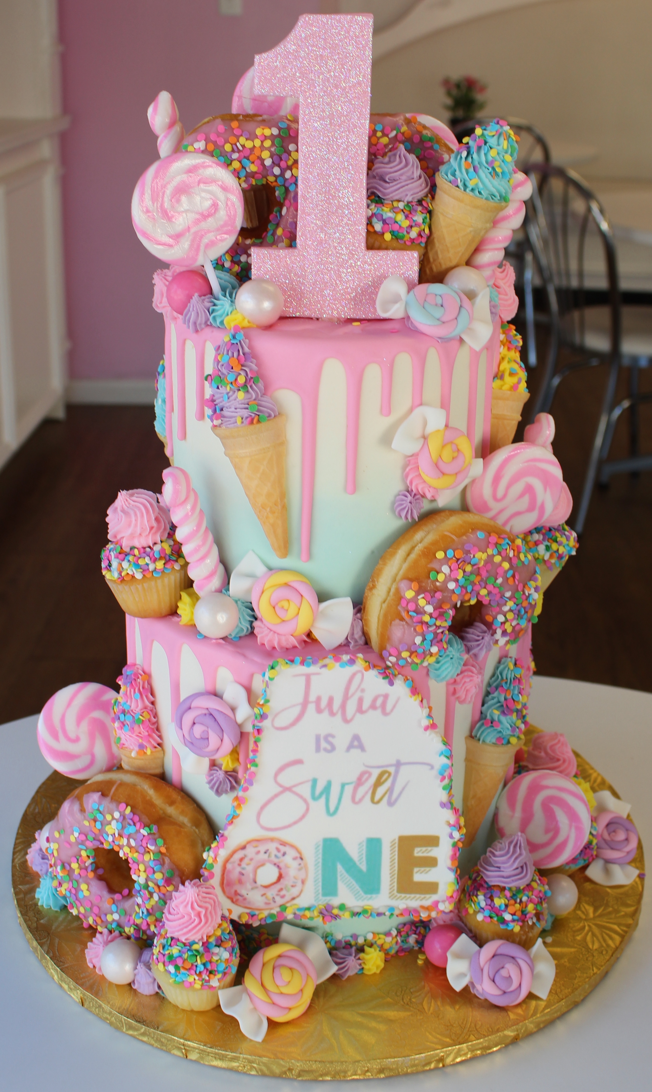 Two Tier Birthday Cake with Candies Donuts Ice Cream Cones and Cupcakes