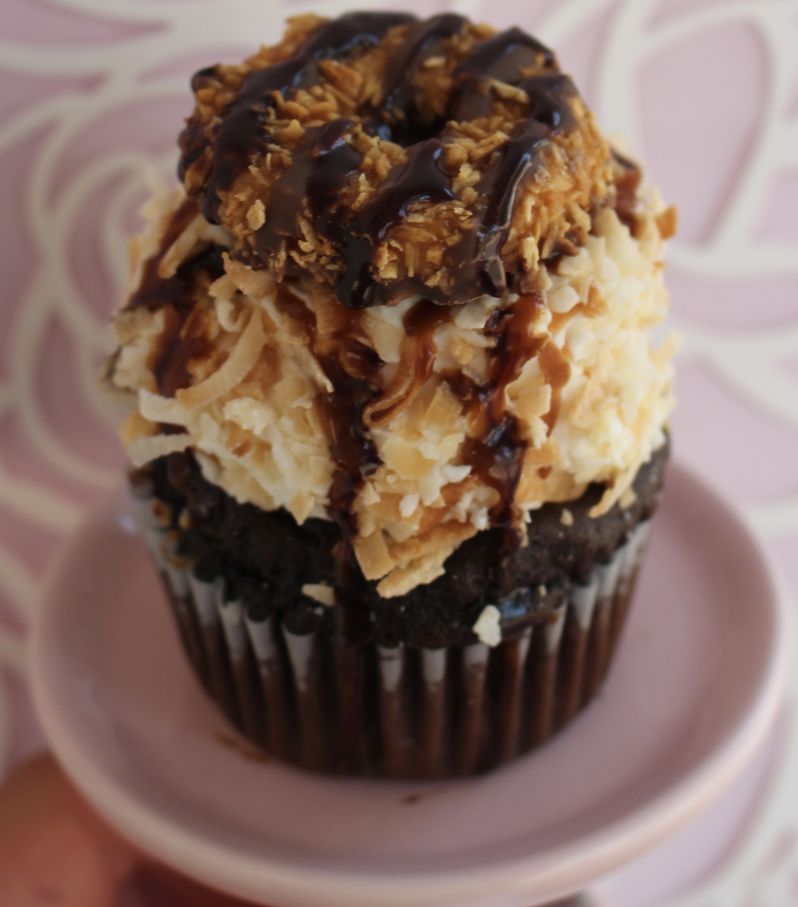 Chocolate cake filled with caramel and topped with a coconut buttercream, toasted coconut, caramel and chocolate drizzle, and a coconut samoa cookie!