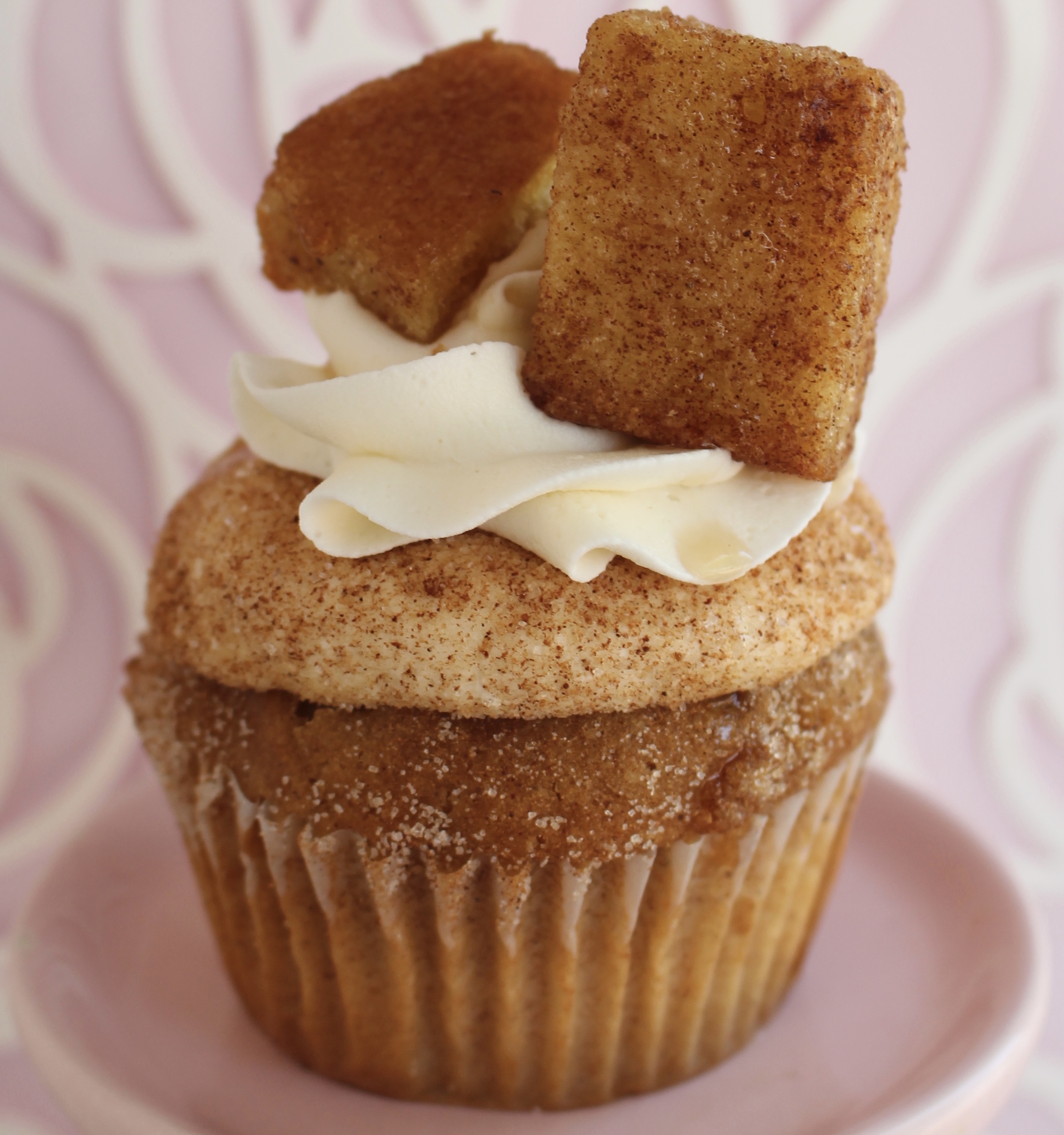 A cinnamon sugar cake filled with maple syrup and topped with vanilla buttercream, cinnamon sugar, and maple syrup!