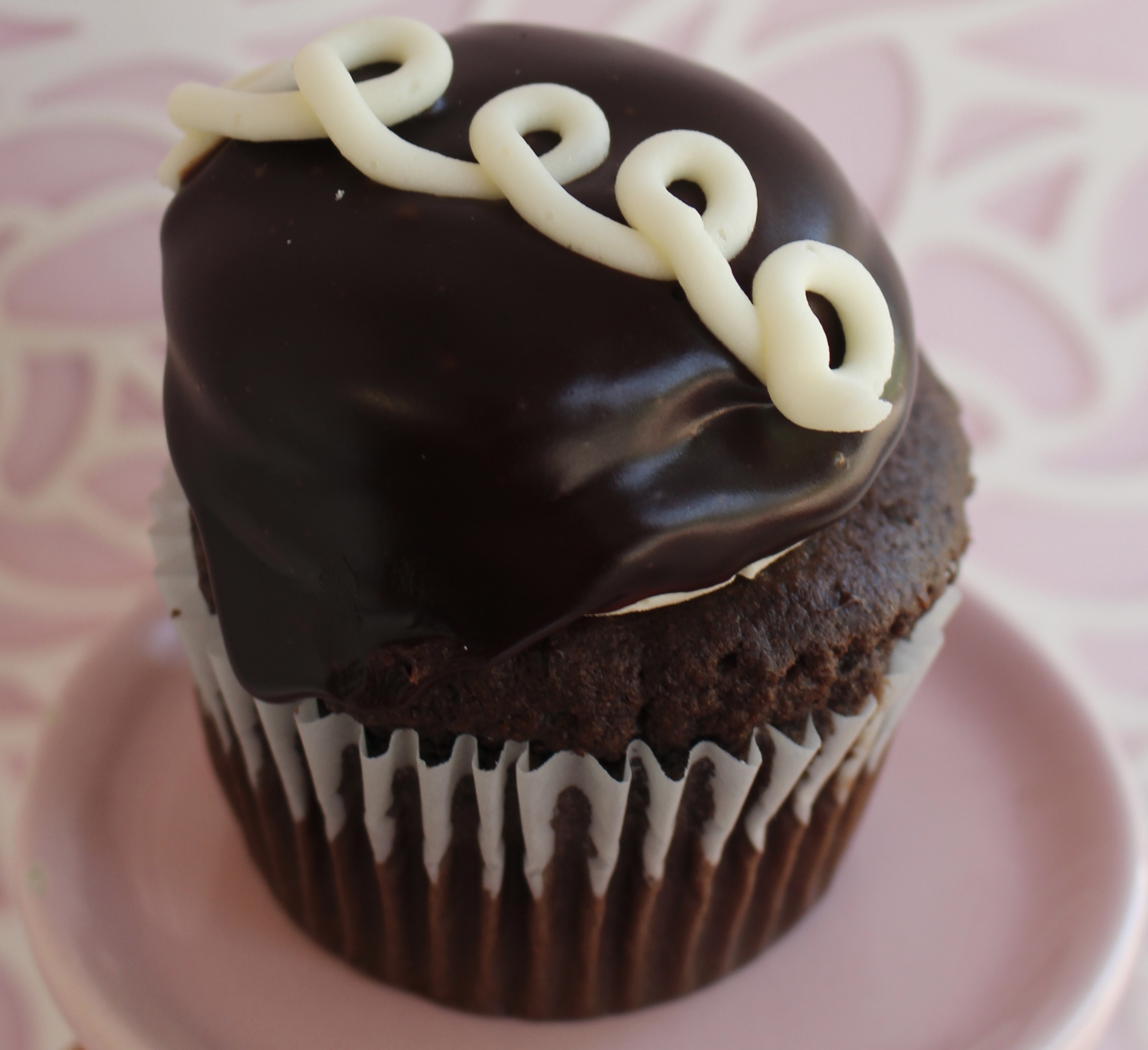 Chocolate cake with vanilla buttercream, dipped in chocolate ganache!