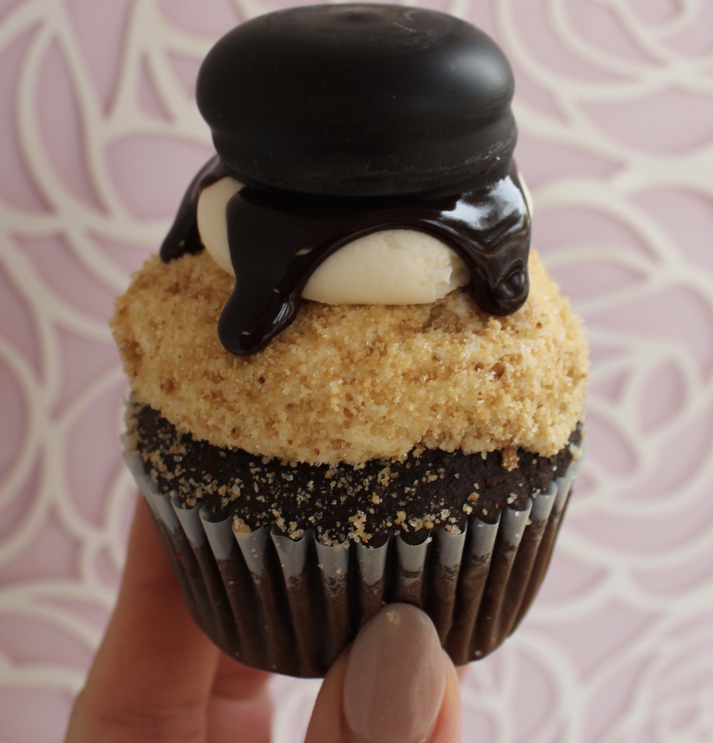 Chocolate cupcake with marshmallow buttercream, graham cracker, and chocolate ganache and a mallomar cookie!