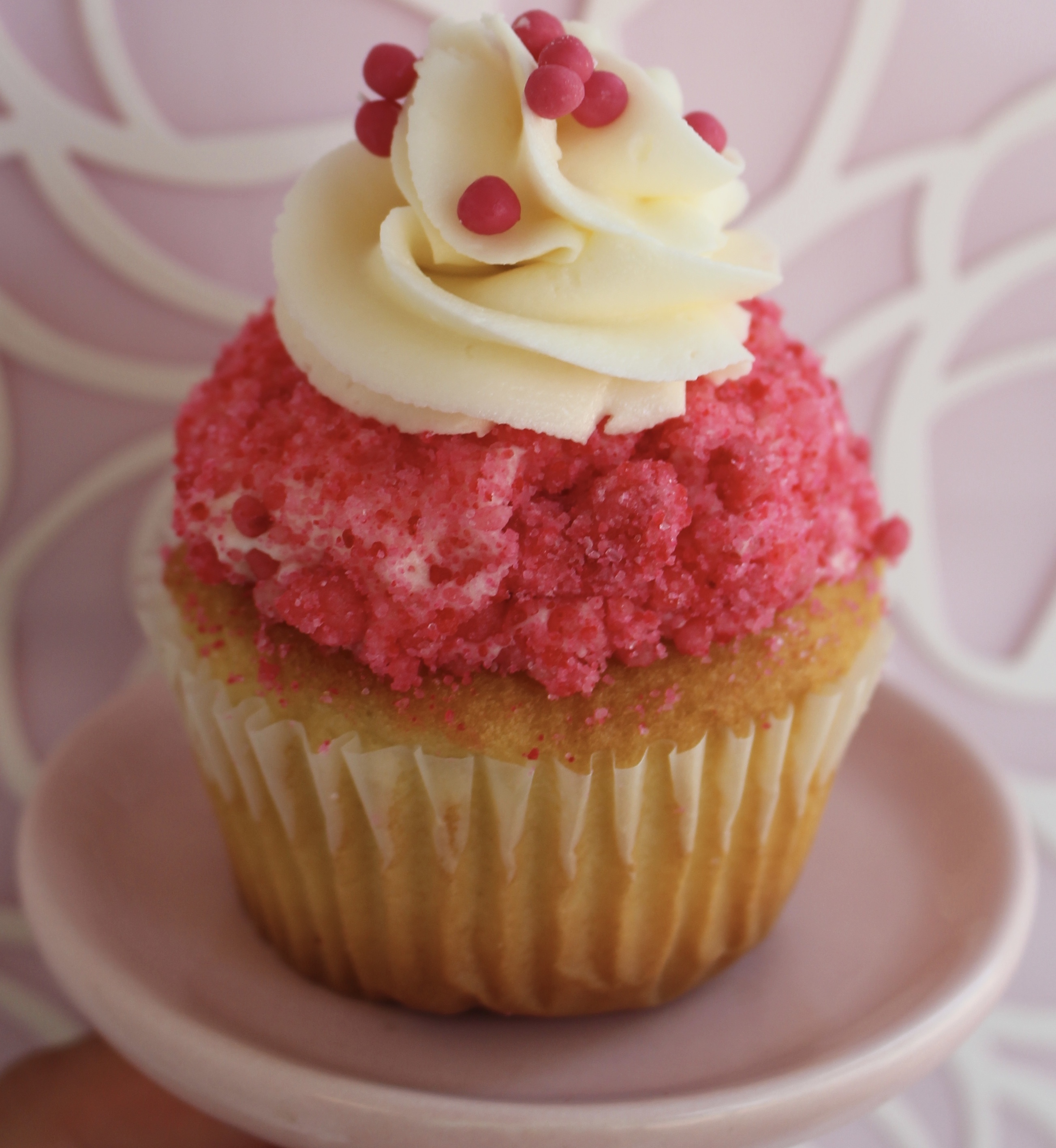Vanilla cake filled with strawberry buttercream and topping with a vanilla cream and strawberry streusel!