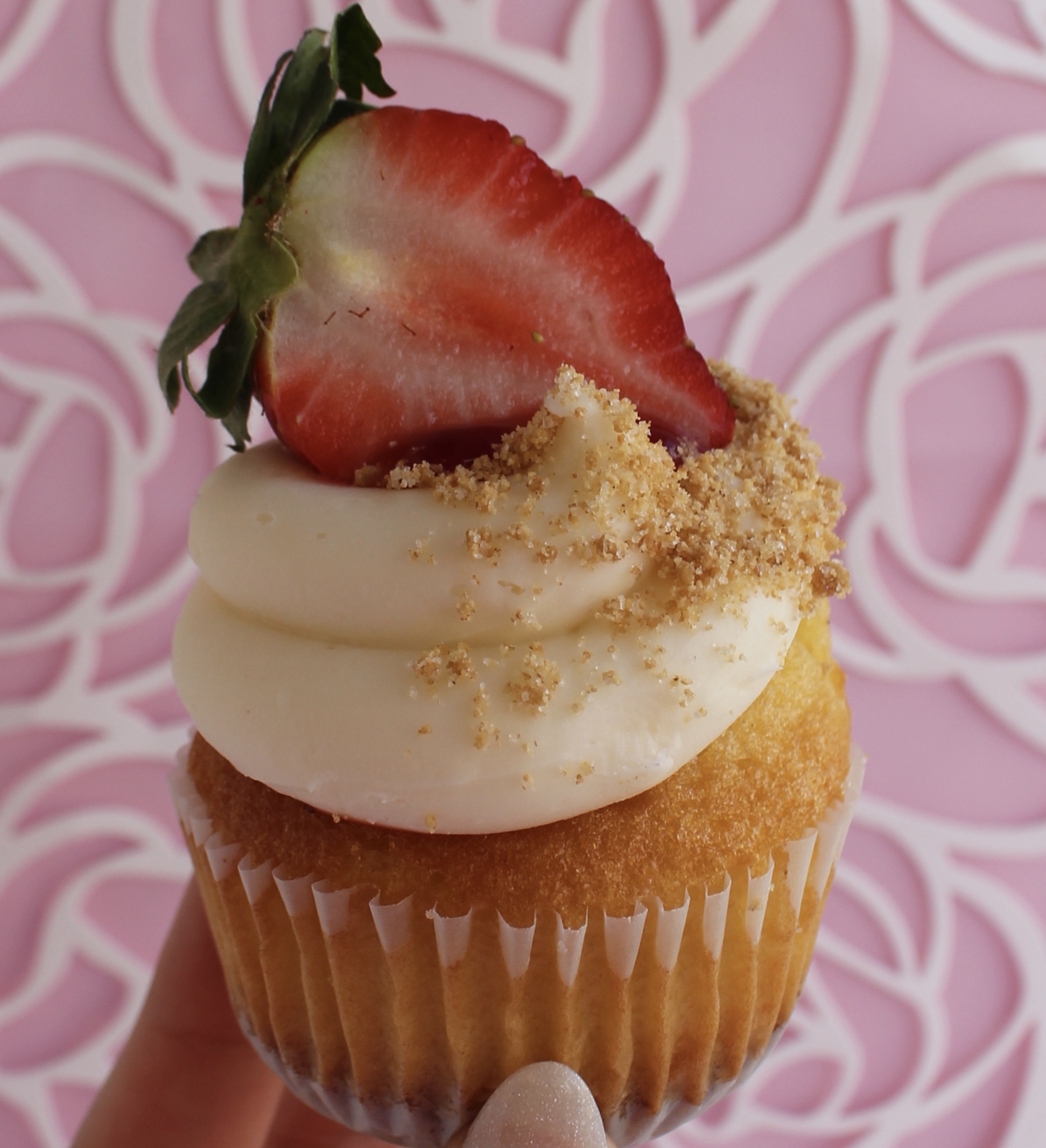 Vanilla cake with a graham cracker cookie bottom, strawberry filling, and cream cheese buttercream toppping!