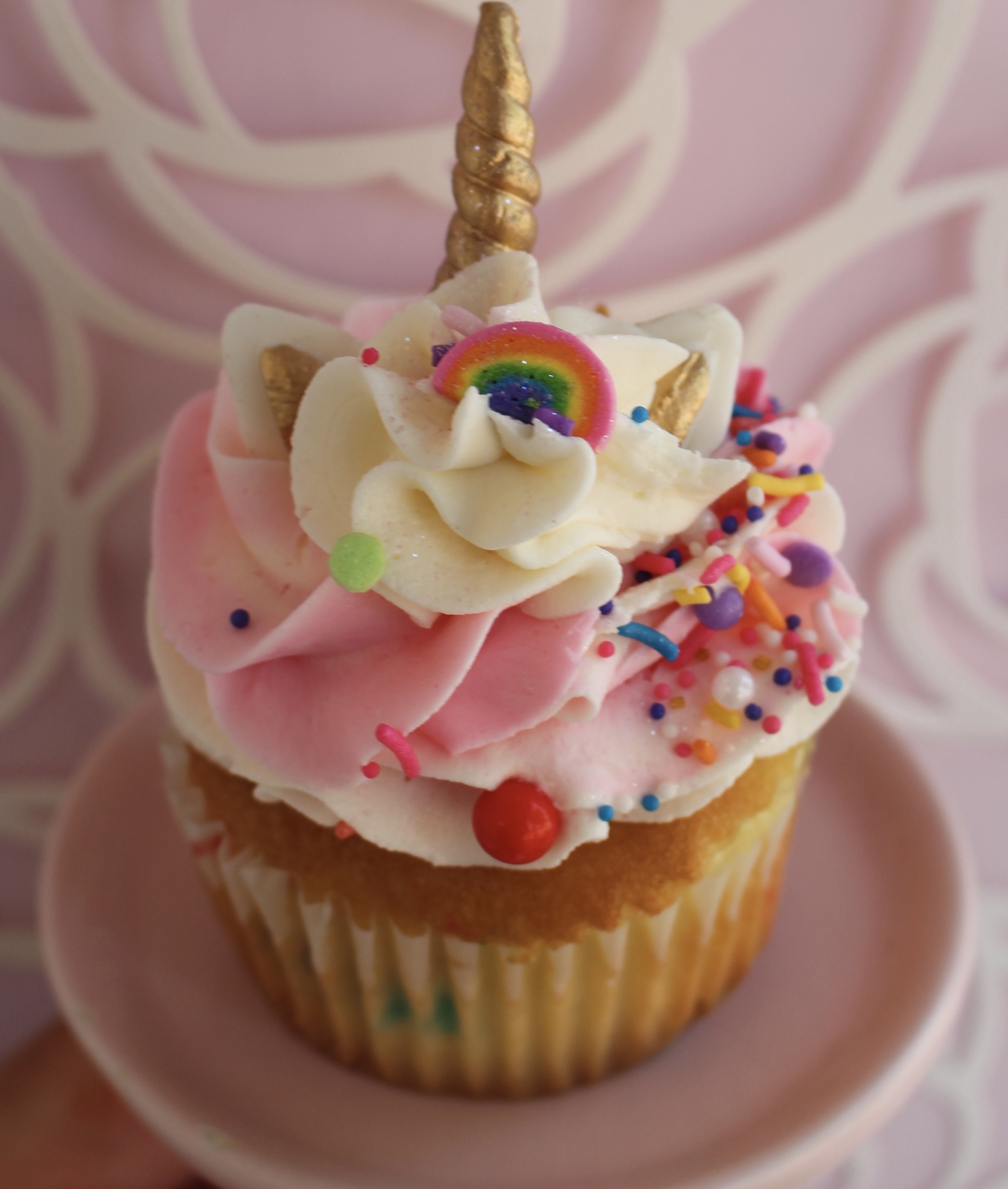 Confetti cake with a vanilla buttercream topping, sprinkles, a unicorn horn, and glitter!
