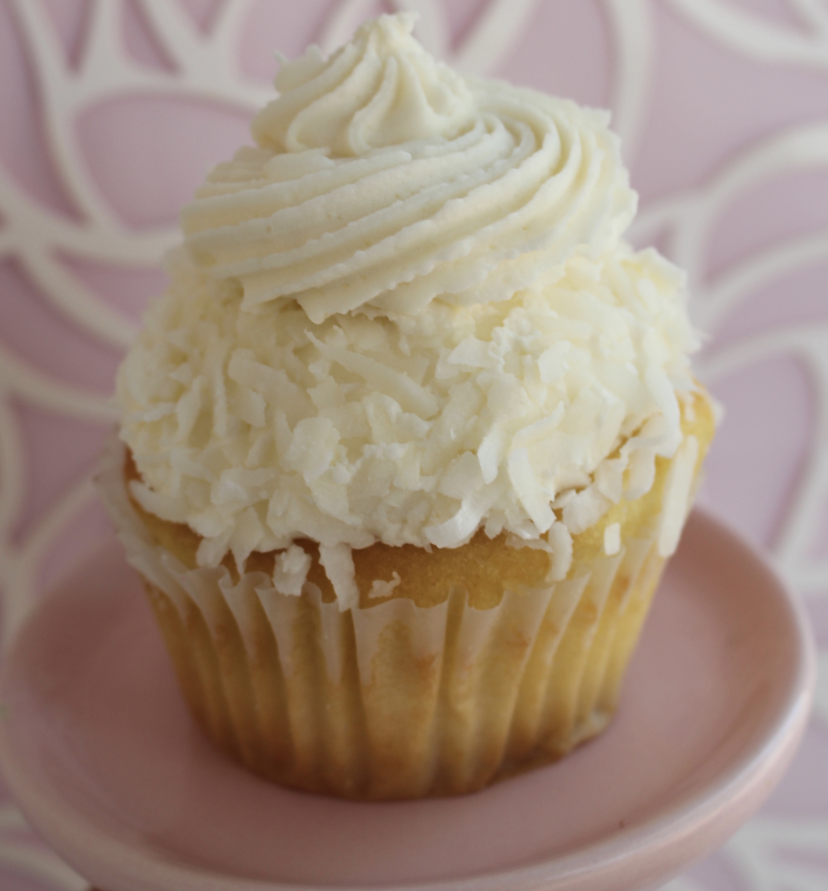 Vanilla cake filled and topped with a coconut buttercream and rolled in coconut shavings!